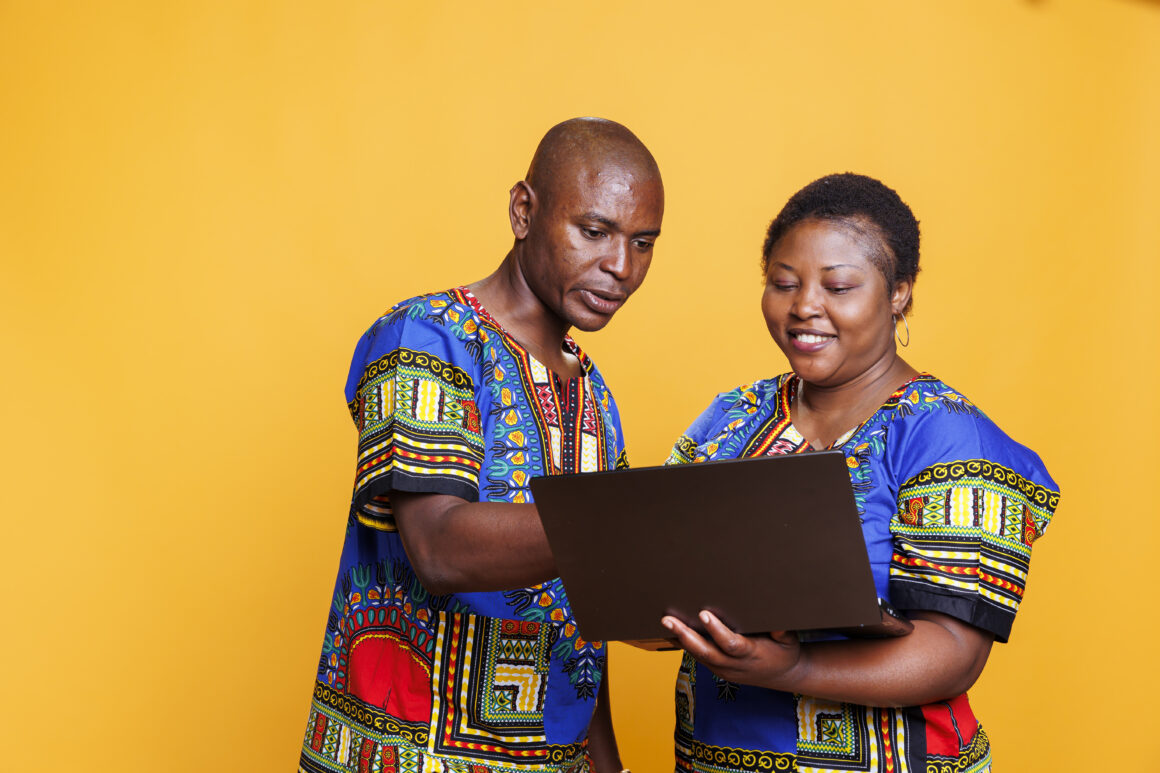Smiling couple using laptop together 5 Ways You Can Finance Better